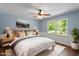Cozy bedroom featuring a ceiling fan, picture window, and neutral decor for a relaxing atmosphere at 5124 Lazywood Ln, Durham, NC 27712