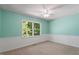 Bedroom featuring a large window and neutral carpet at 5124 Lazywood Ln, Durham, NC 27712