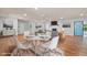 Open dining space that flows into the living room, with a view of the fireplace at 5124 Lazywood Ln, Durham, NC 27712