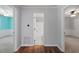 Hallway with hardwood flooring and views into the bedrooms and bathroom at 5124 Lazywood Ln, Durham, NC 27712