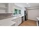 Updated kitchen with sleek stainless steel appliances, modern countertops and wood-look floors at 5124 Lazywood Ln, Durham, NC 27712