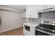 Kitchen area featuring stainless steel stove, modern countertops and ample cabinet space at 5124 Lazywood Ln, Durham, NC 27712