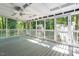 Spacious screened-in patio with white railing and wood flooring at 5124 Lazywood Ln, Durham, NC 27712
