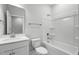 Bathroom with a shower-tub combo, white vanity and sink and neutral colored walls at 529 Forestville Rd, Wake Forest, NC 27587