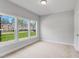 Bedroom with neutral carpet, three large windows for plenty of natural light, and neutral colored walls at 529 Forestville Rd, Wake Forest, NC 27587