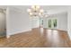 Open dining area features wood flooring, a modern chandelier, and lots of natural light at 529 Forestville Rd, Wake Forest, NC 27587