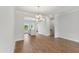 Open dining area with hardwood floors next to an eat-in kitchen with a breakfast bar at 529 Forestville Rd, Wake Forest, NC 27587
