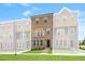 Brick townhome features a manicured lawn, neutral paint and charming black trimmed windows and doors at 529 Forestville Rd, Wake Forest, NC 27587