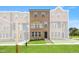 Brick townhome features a manicured lawn, neutral paint and charming black trimmed windows and doors at 529 Forestville Rd, Wake Forest, NC 27587