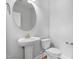 Modern half bathroom featuring a pedestal sink and toilet at 529 Forestville Rd, Wake Forest, NC 27587