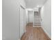 Hallway with hardwood style floors, white trim and neutral colored walls at 529 Forestville Rd, Wake Forest, NC 27587