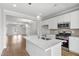 Contemporary kitchen with white cabinetry, stainless steel appliances, and an island overlooking the living room at 529 Forestville Rd, Wake Forest, NC 27587