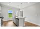 A bright kitchen with a center island, stainless steel appliances, and a view of the yard at 529 Forestville Rd, Wake Forest, NC 27587
