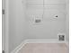 Bright laundry room features tile flooring, utility connections, and wire shelving for efficient organization at 529 Forestville Rd, Wake Forest, NC 27587