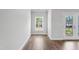 Bright, open room with hardwood flooring, a window, and a glass door to the outside at 529 Forestville Rd, Wake Forest, NC 27587