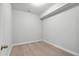 Empty room with neutral carpet, a single light fixture, neutral colored walls and white trim at 529 Forestville Rd, Wake Forest, NC 27587