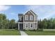 Inviting two-story home featuring stone accents, gray siding and beautifully landscaped front yard at 5537 Cayden Cove Dr, Wendell, NC 27591