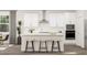 Bright kitchen features white cabinets, stainless steel appliances, island with seating, and pendant lighting at 5553 Cayden Cove Dr, Wendell, NC 27591