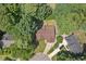 Aerial view of a home nestled among lush greenery and mature trees at 6205 Houndsman Ct, Raleigh, NC 27616