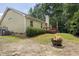 Spacious backyard featuring a fire pit and mature trees, ideal for outdoor enjoyment at 6205 Houndsman Ct, Raleigh, NC 27616