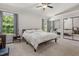 Bright bedroom featuring a ceiling fan, large windows, and mirrored closet doors at 6205 Houndsman Ct, Raleigh, NC 27616