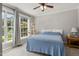 Bedroom with big windows and natural light showcasing a ceiling fan, and carpeted floors at 6205 Houndsman Ct, Raleigh, NC 27616
