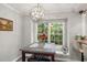 Inviting dining area with a modern light fixture and a large window offering natural light at 6205 Houndsman Ct, Raleigh, NC 27616