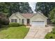 Charming single-story home with a well-manicured lawn and a two-car garage at 6205 Houndsman Ct, Raleigh, NC 27616