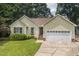 Charming single-story home with a well-manicured lawn, two-car garage and traditional architectural details at 6205 Houndsman Ct, Raleigh, NC 27616