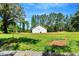 Back of home is surrounded by beautiful green trees and a blue sky at 7082 Cornwall Rd, Oxford, NC 27565