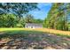 A peaceful backyard with mature trees at 7082 Cornwall Rd, Oxford, NC 27565
