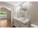Bathroom featuring a double vanity with modern fixtures, view to adjacent room, neutral color palette at 7082 Cornwall Rd, Oxford, NC 27565