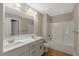 Bright bathroom with double vanity, white cabinets, and a tub/shower combination at 7082 Cornwall Rd, Oxford, NC 27565