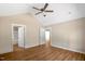 Modern bedroom with vaulted ceiling, fan, neutral paint, and wood-look floors at 7082 Cornwall Rd, Oxford, NC 27565