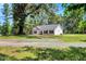 Well-maintained home exterior with lush greenery and mature trees at 7082 Cornwall Rd, Oxford, NC 27565