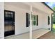 Inviting front porch with a stylish black front door and visible house number at 7082 Cornwall Rd, Oxford, NC 27565