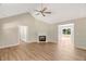 Bright living room with fireplace, ceiling fan, and luxury vinyl plank flooring at 7082 Cornwall Rd, Oxford, NC 27565