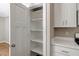 Bright and clean white pantry with shelving in a modern kitchen at 7082 Cornwall Rd, Oxford, NC 27565