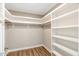 Spacious walk-in closet with built-in shelving and wood-look floors at 7082 Cornwall Rd, Oxford, NC 27565