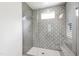Modern shower with glass door and tiled walls and floors with built in seat at 7304 Wexford Woods Ln, Wake Forest, NC 27587