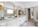 Elegant bathroom featuring dual vanities and classic fixtures at 7304 Wexford Woods Ln, Wake Forest, NC 27587