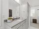 Bathroom featuring a decorative mirror, sink and stone countertops with pull out drawers at 7304 Wexford Woods Ln, Wake Forest, NC 27587