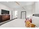 Bedroom featuring a ceiling fan, TV and mirror, and a bed with decorative pillows at 7304 Wexford Woods Ln, Wake Forest, NC 27587