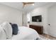 Bedroom with a wooden ceiling fan, TV and built in drawers for storage at 7304 Wexford Woods Ln, Wake Forest, NC 27587
