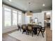 Elegant dining room with hardwood floors, large windows and stylish light fixture for sophisticated meals at 7304 Wexford Woods Ln, Wake Forest, NC 27587