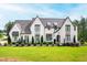 Stunning two-story painted brick home with professionally landscaped front yard and beautiful architectural details at 7304 Wexford Woods Ln, Wake Forest, NC 27587