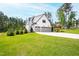 Stunning two-story home with a three-car garage and well-manicured lawn at 7304 Wexford Woods Ln, Wake Forest, NC 27587