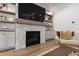 Stylish fireplace with built-in shelving, cabinets, and a large screen TV at 7304 Wexford Woods Ln, Wake Forest, NC 27587