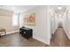 Hallway with hardwood floors, decorative art, and natural light from the window at 7304 Wexford Woods Ln, Wake Forest, NC 27587