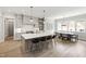 Charming kitchen featuring a large island with seating, pendant lights, and views of the breakfast nook at 7304 Wexford Woods Ln, Wake Forest, NC 27587